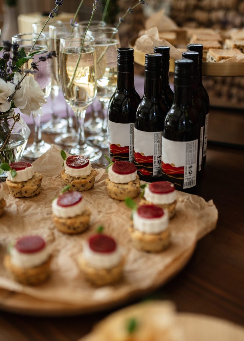 welcome buffet with alcohol and snacks, sandwiches, cupcakes